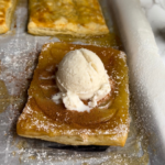 apple cinnamon pastry turnover with a scoop of vanilla ice cream