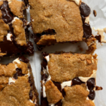 Overhead shot of the S'mores Cookie Bars cut on parchment paper.