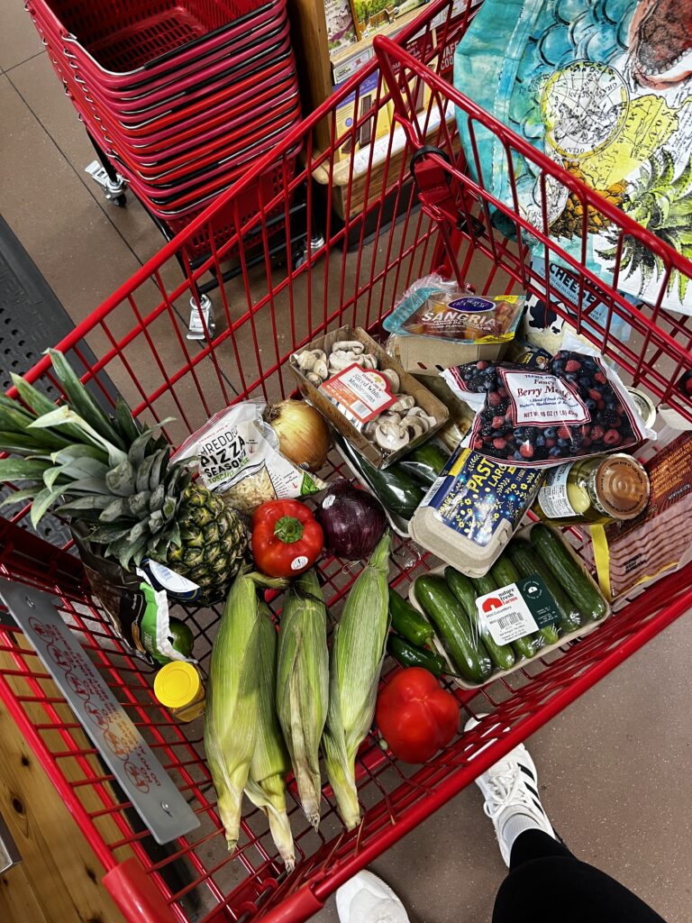 image of Trader Joe's shopping cart from above with various items in the cart. 