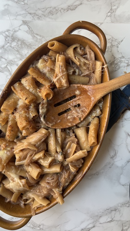 Creamy french onion pasta from above with spoon scooping out pasta