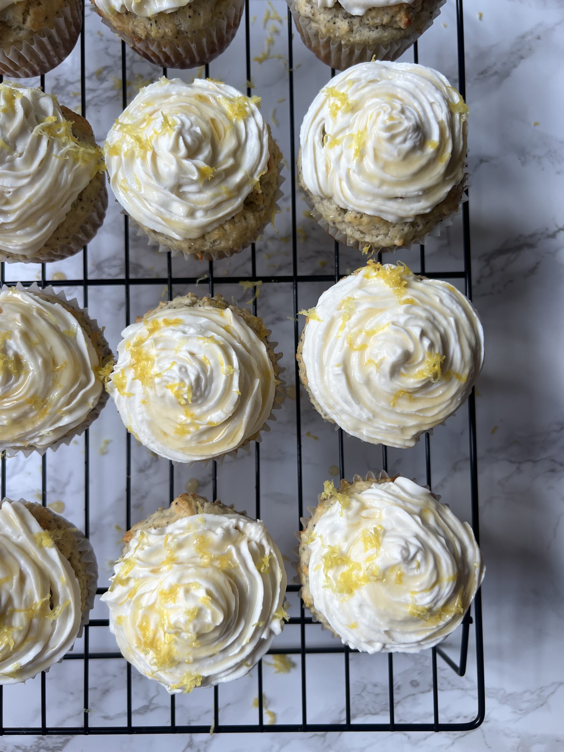 close up arial view of lemon poppyseed muffins with honey ricotta frosting