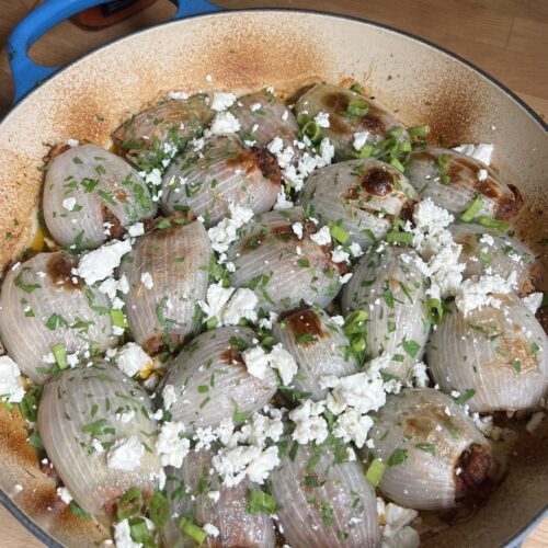 roasted stuffed onions in a baking dish from above