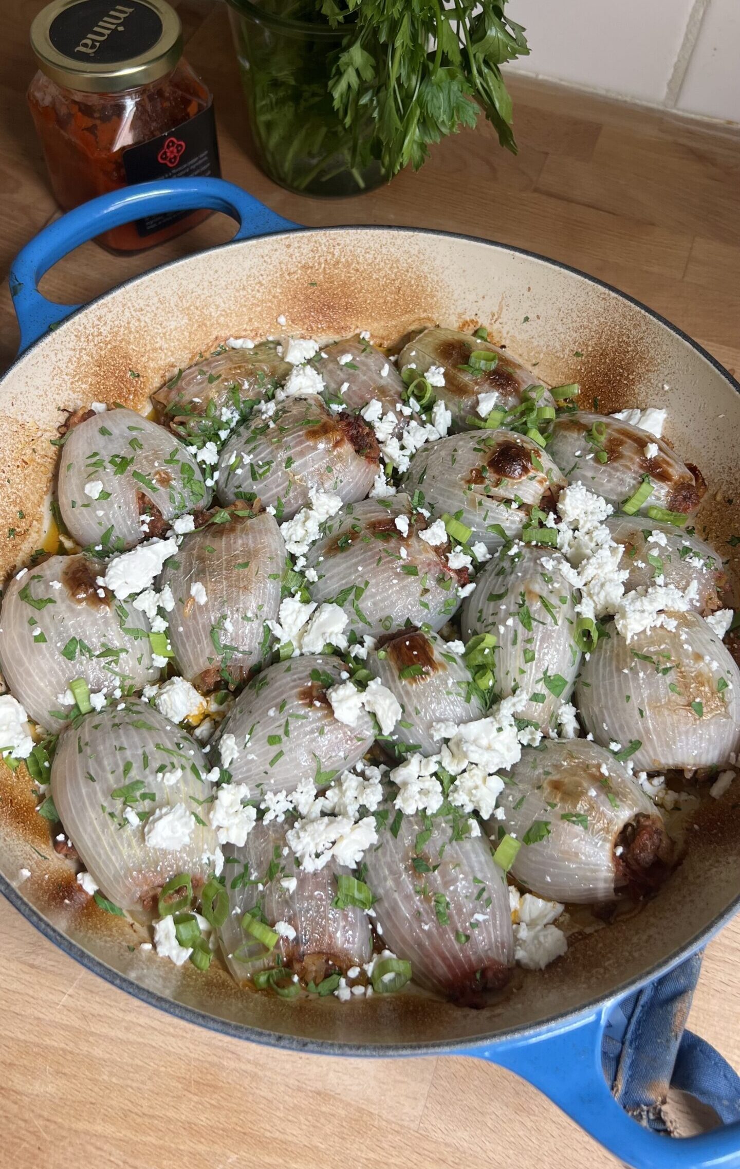 roasted stuffed onions in a baking dish from above