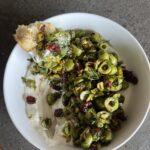 olive dip from above with bread dipped in
