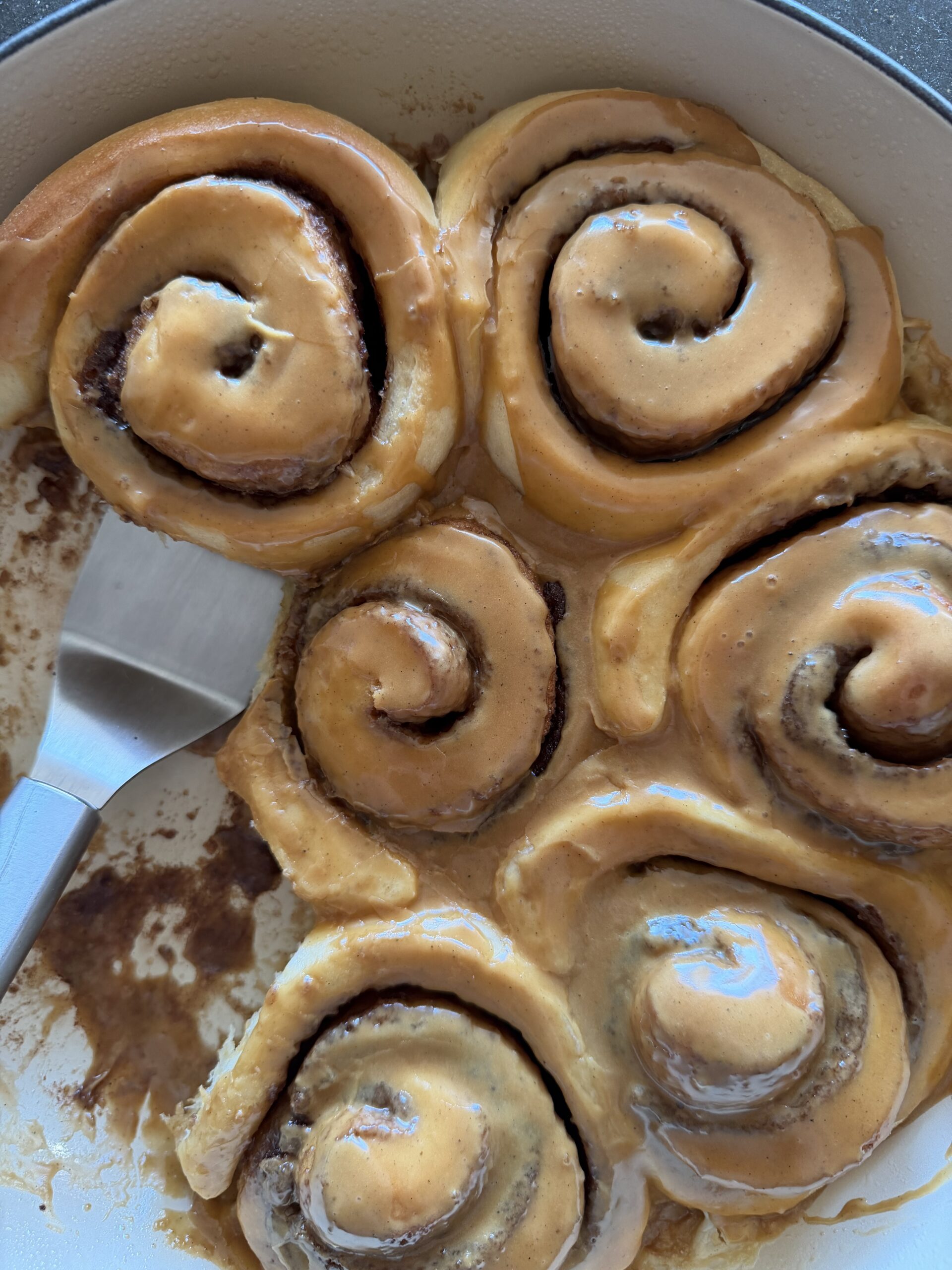 cinnamon rolls from above with spatula